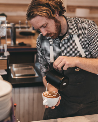 Barista pouring a latte