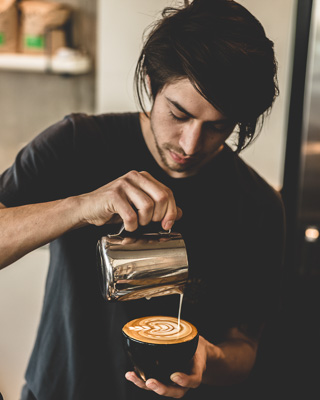 Barista pouring a latte