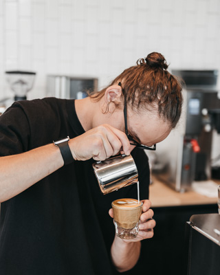 Barista pouring a latte