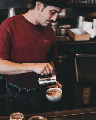 Barista pouring a latte