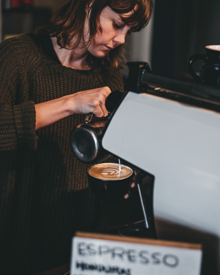 Barista pouring a latte