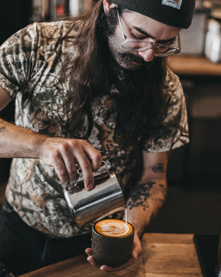 Barista pouring a latte