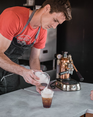 Barista pouring a latte